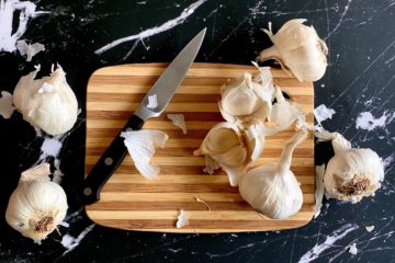 How to Peel Garlic: Garlic sitting on a cutting board