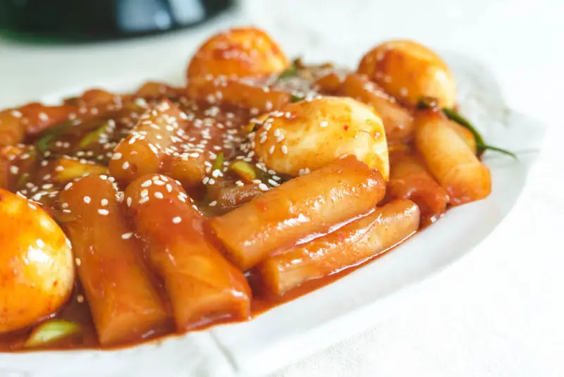 A platter of bright red rice paper tteokbokki. 