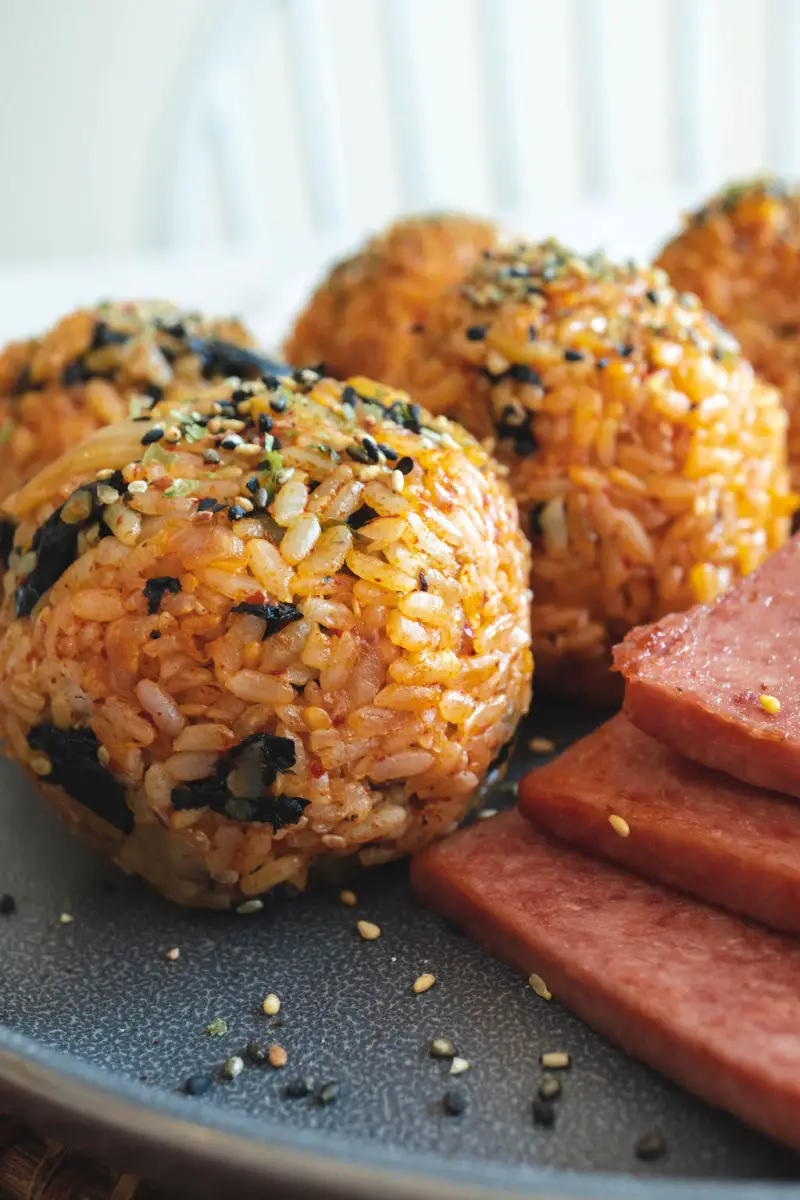 A side shot of kimchi rice balls next to spam. 