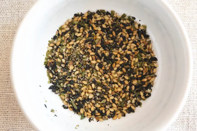 An overhead shot of a white bowl filled with Japanese furikake.