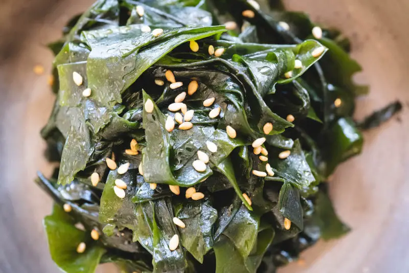 A close overhead shot of Korean seaweed salad. Sesame seeds sprinkled over the top.