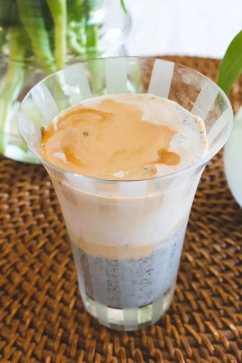 An overhead shot of this nutty coffee drink next to vases. 