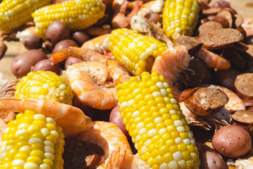 A closeup shot of Lowcountry shrimp boil including shrimp, sausage, corn, and potatoes