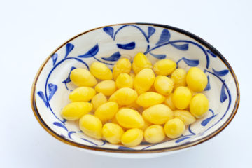 Ginkgo nuts in a blue and white bowl.