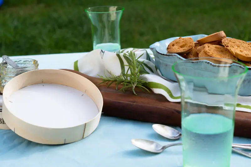 A table set with toasted bread and glasses. 