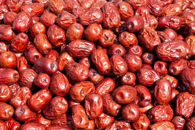 An overhead shot of dried jujubes in a large pile. 