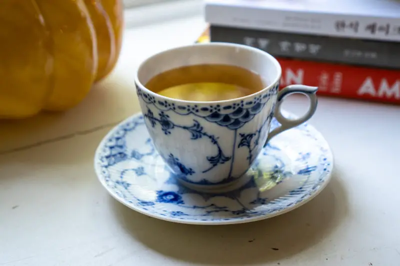 Korean plum tea in a blue and white tea cup. 