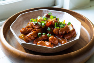 Korean sausage stir fry in a bowl. The stir fry is topped with green onions