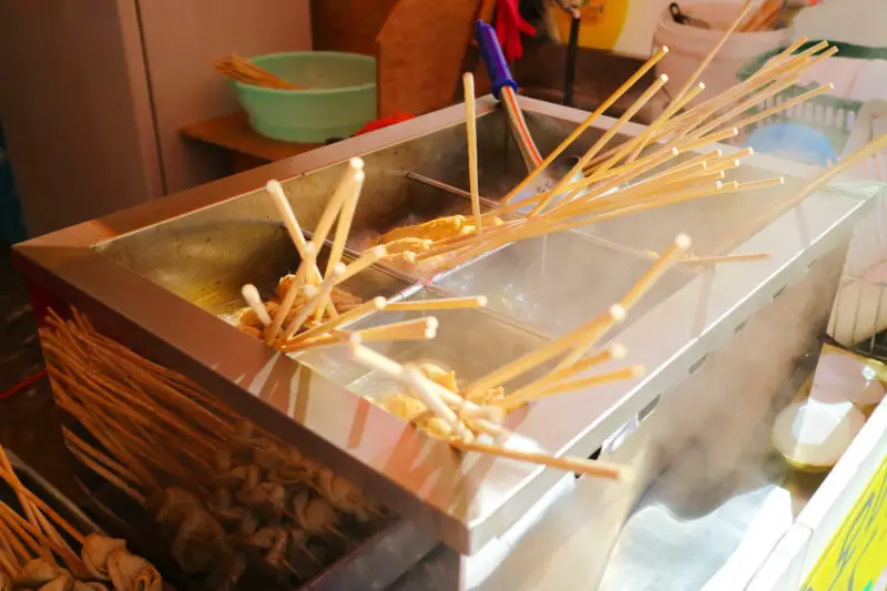 Korean fish cakes in broth. The fish cakes are on sticks. 