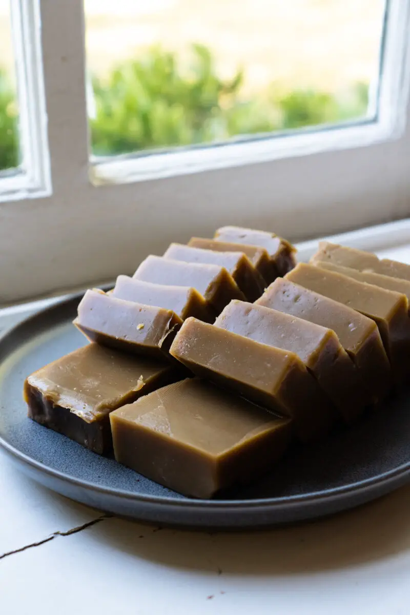 Korean acorn jelly (dotorimuk) on a gray plate. This jelly is sliced. 