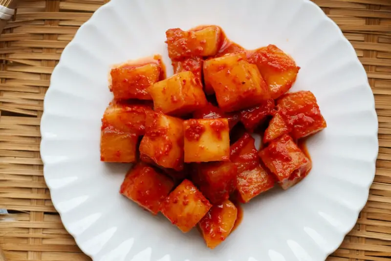Korean radish kimchi on a white plate. 