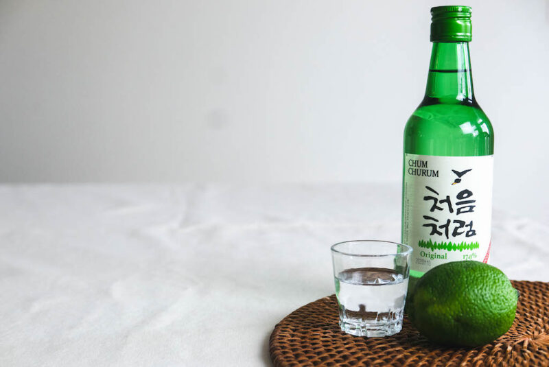 Soju next to a lime and soju glass. 
