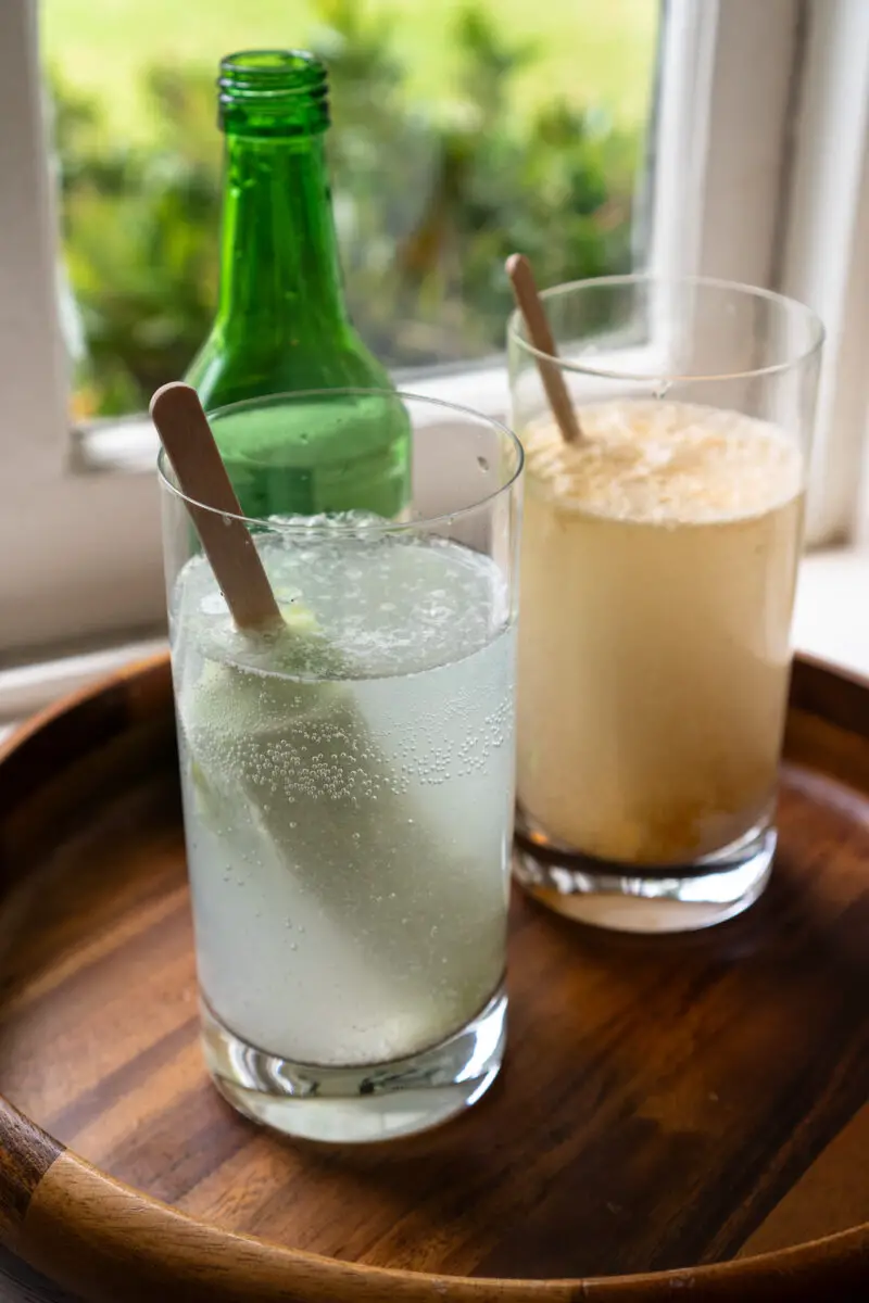 A side shot of ice cream sitting in a glass filled with your alcohol and tonic water. The glass sits on a tray. 